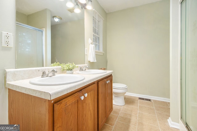 bathroom with tile patterned flooring, a chandelier, a shower with shower door, vanity, and toilet