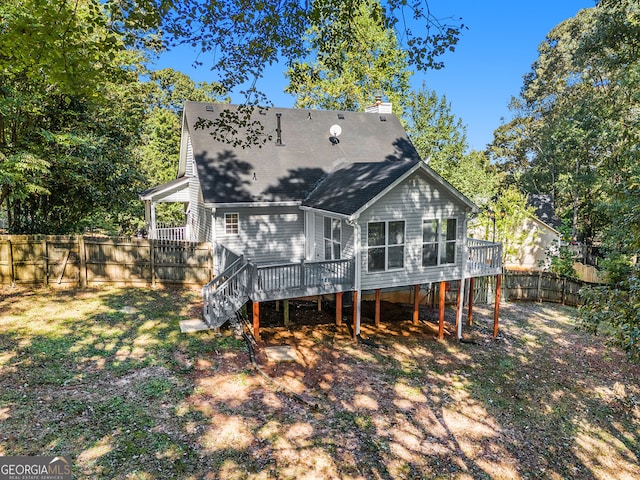 back of house with a sunroom and a deck