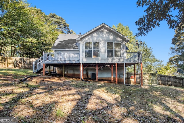 rear view of property with a deck and central AC unit