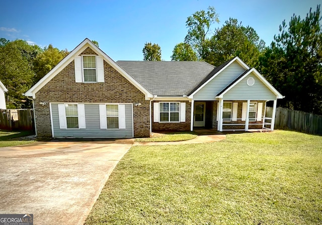 view of front of house featuring covered porch and a front lawn