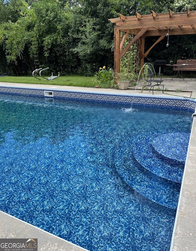 view of swimming pool featuring a pergola