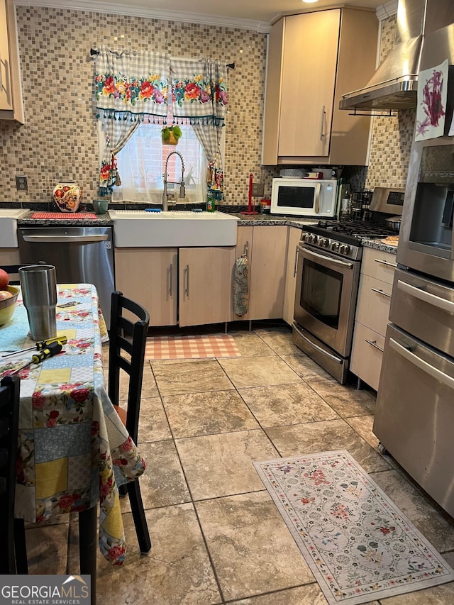 kitchen with backsplash, stainless steel appliances, crown molding, sink, and wall chimney range hood