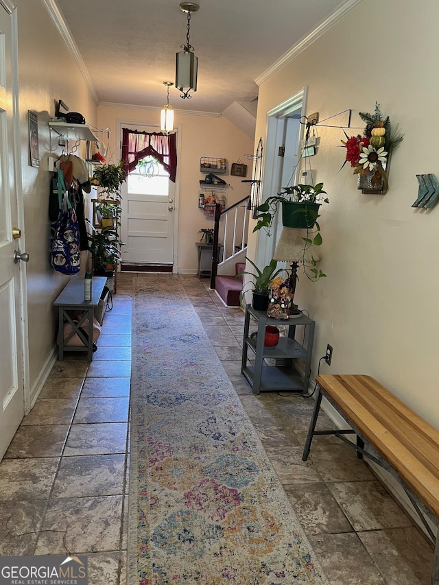 entryway featuring vaulted ceiling and crown molding