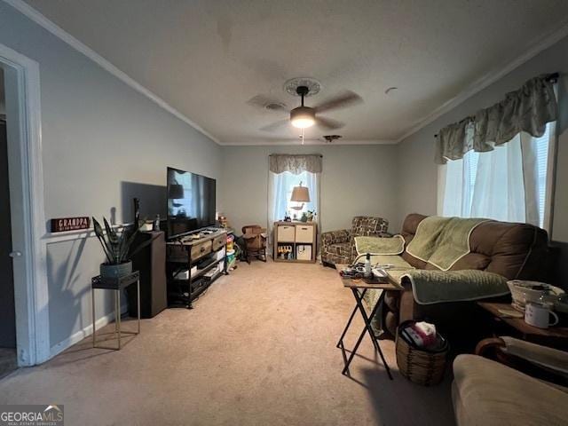 living room featuring carpet, ceiling fan, and crown molding