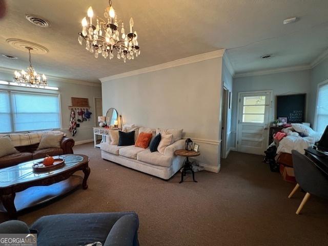 living room with carpet flooring, crown molding, and a notable chandelier