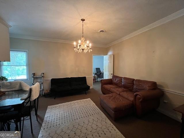 living room featuring ornamental molding and a chandelier