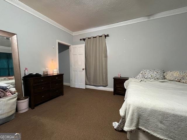 carpeted bedroom with a textured ceiling and ornamental molding