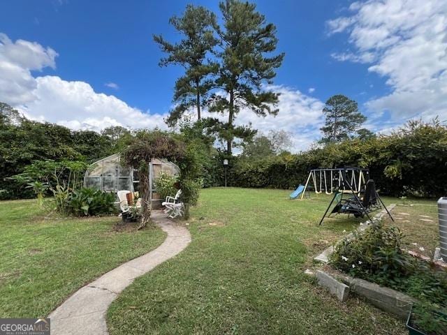 view of yard featuring an outbuilding and a playground