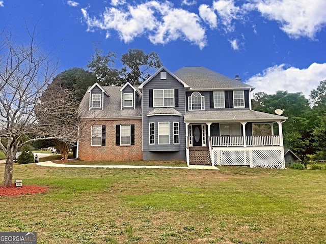 view of front of home with a front yard and a porch