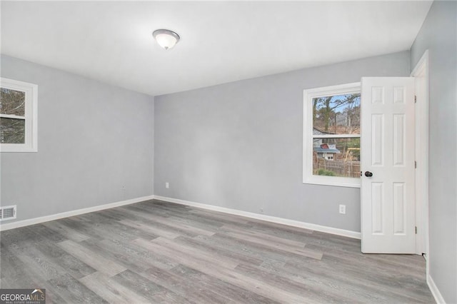 empty room with light hardwood / wood-style floors