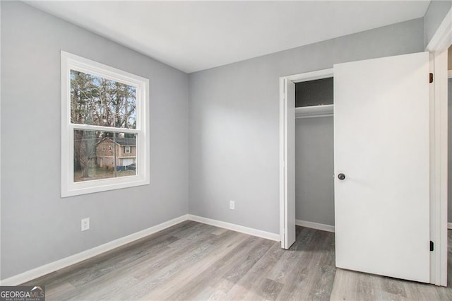 unfurnished bedroom with light hardwood / wood-style floors and a closet