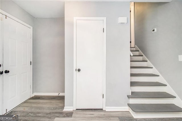 stairs featuring hardwood / wood-style floors