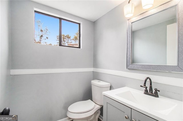 bathroom featuring vanity and toilet