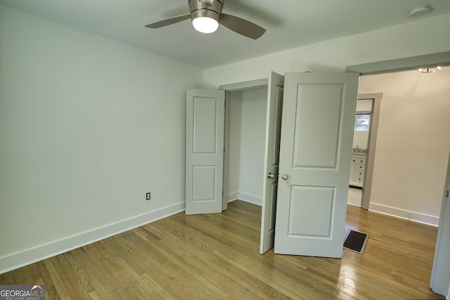 unfurnished bedroom with ceiling fan and light hardwood / wood-style flooring