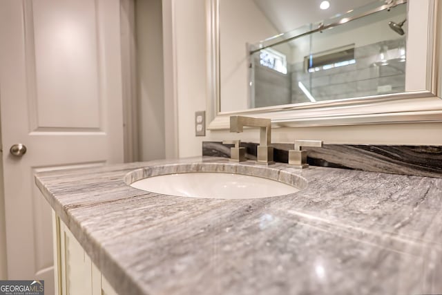 bathroom featuring vanity and an enclosed shower