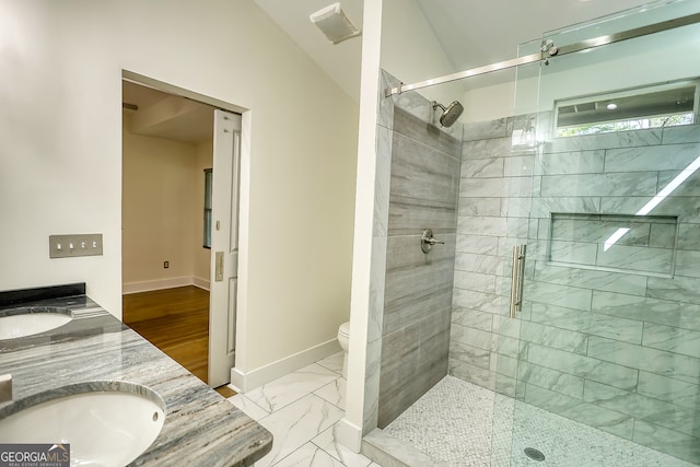 bathroom with a shower with shower door, vanity, wood-type flooring, lofted ceiling, and toilet