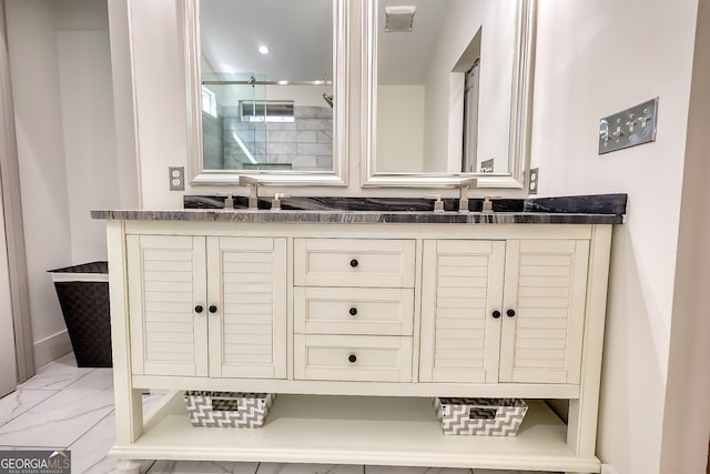 bathroom featuring walk in shower and vanity