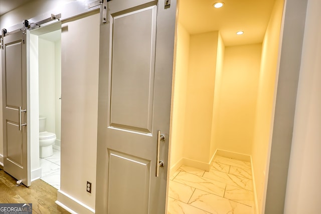 hallway featuring a barn door