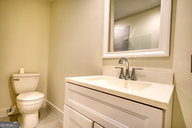 bathroom featuring tile patterned floors, vanity, and toilet