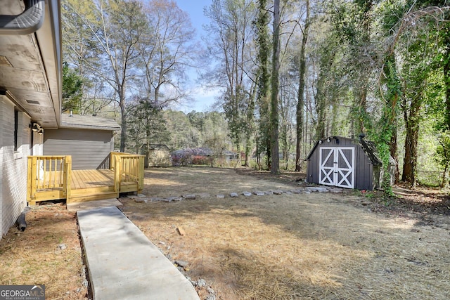 view of yard with a deck and a storage unit