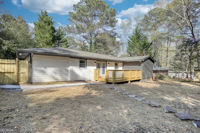 back of property with a wooden deck