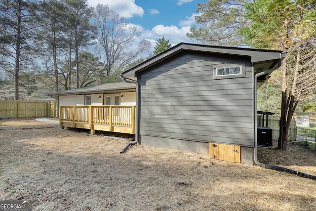 back of house featuring a wooden deck and cooling unit