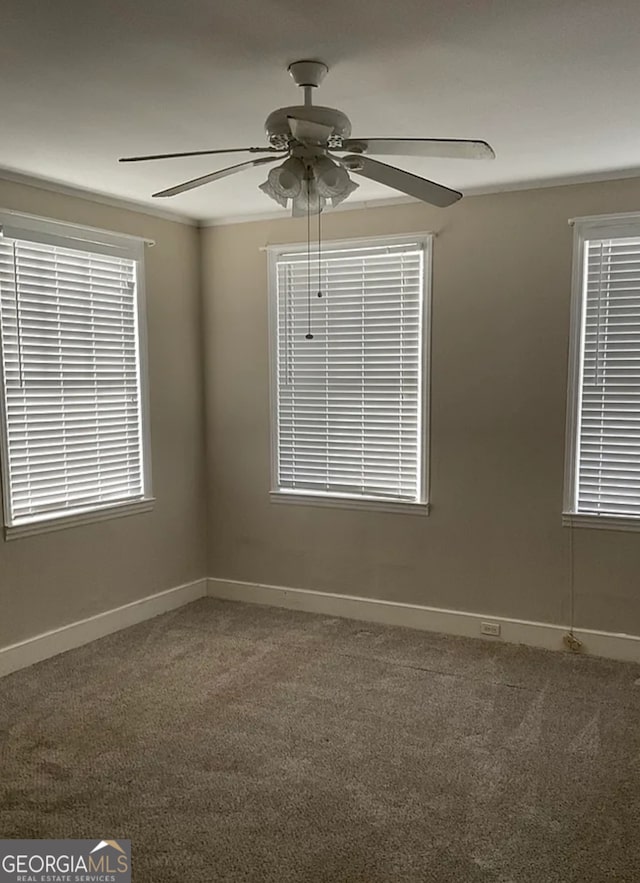 carpeted empty room featuring ceiling fan