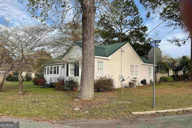 view of side of home with a lawn