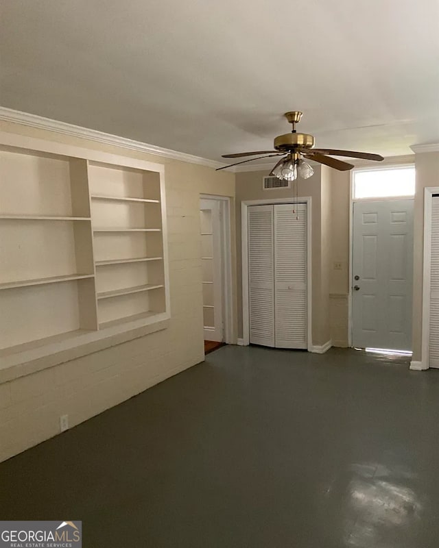 unfurnished living room featuring ceiling fan and crown molding