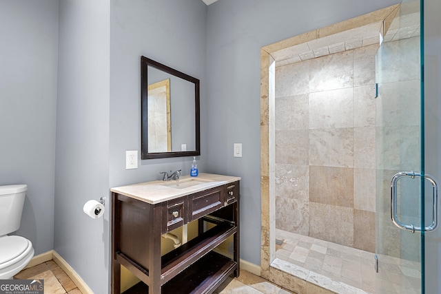 bathroom with vanity, a shower with shower door, and toilet