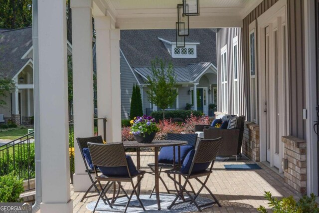 craftsman-style house featuring covered porch, french doors, and a front yard