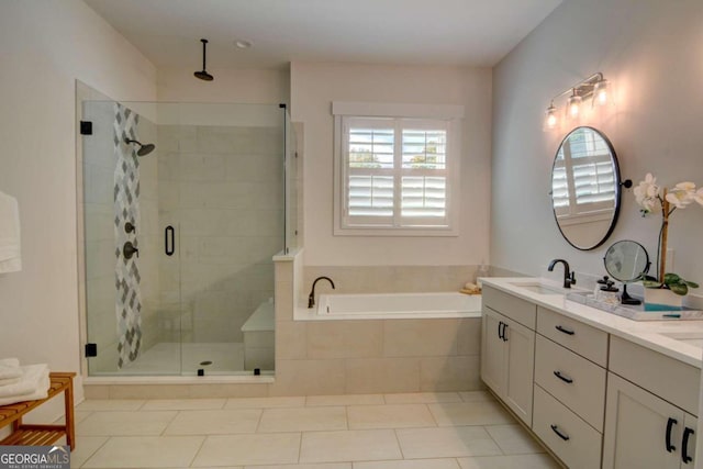 full bath with a bath, a wealth of natural light, a shower stall, and a sink