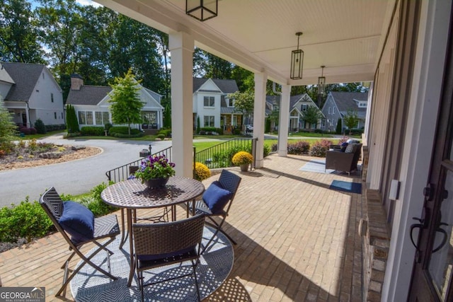 view of patio / terrace featuring a residential view and covered porch