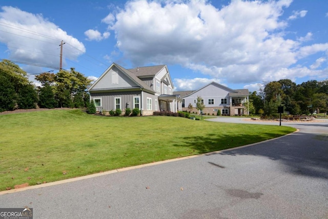 view of front of house featuring a front lawn and board and batten siding