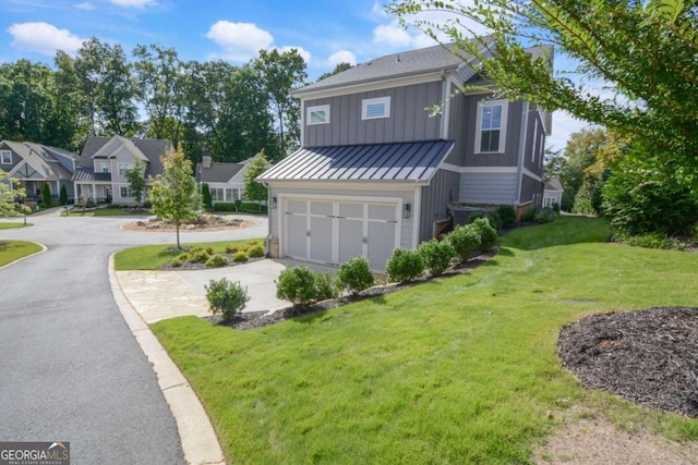 view of front facade with driveway, an attached garage, a standing seam roof, board and batten siding, and a front yard