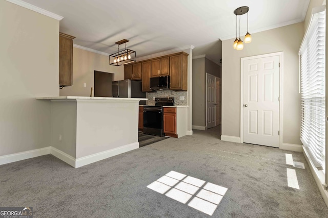 kitchen featuring hanging light fixtures, ornamental molding, tasteful backsplash, black appliances, and light carpet