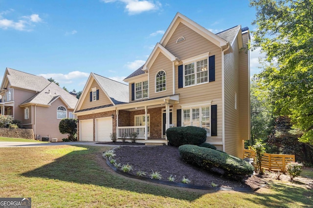 view of front of property with a garage and a front lawn