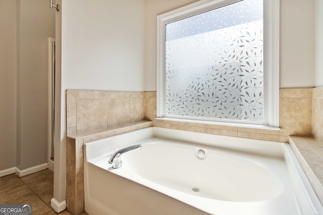 bathroom with a bathing tub and tile patterned floors