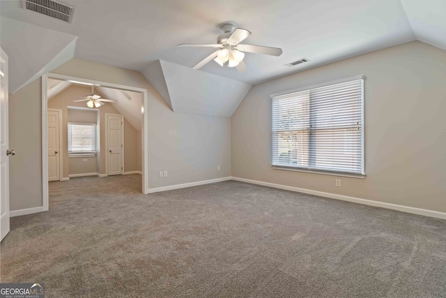 additional living space featuring ceiling fan, vaulted ceiling, and carpet flooring