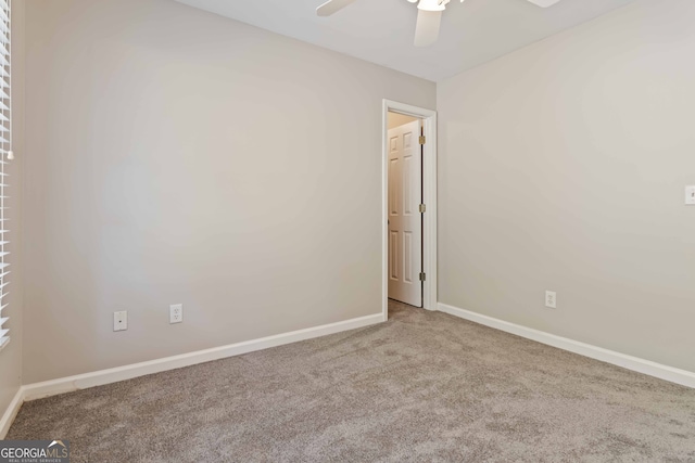 spare room featuring ceiling fan and carpet