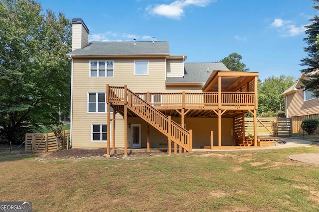 back of property featuring a wooden deck and a lawn