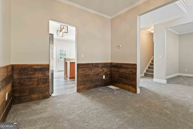 carpeted empty room featuring ornamental molding