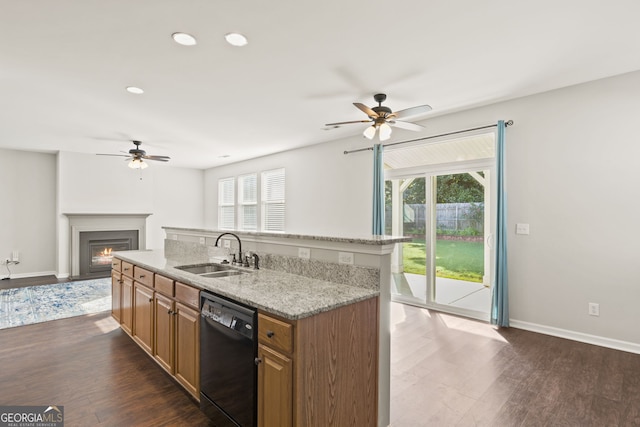 kitchen featuring dishwasher, a kitchen island with sink, sink, and a healthy amount of sunlight