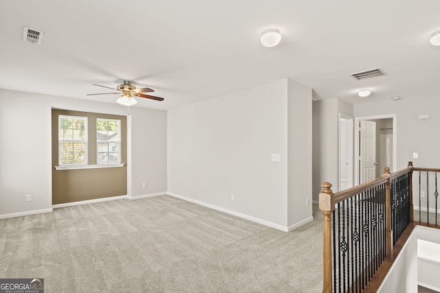 carpeted empty room with ceiling fan