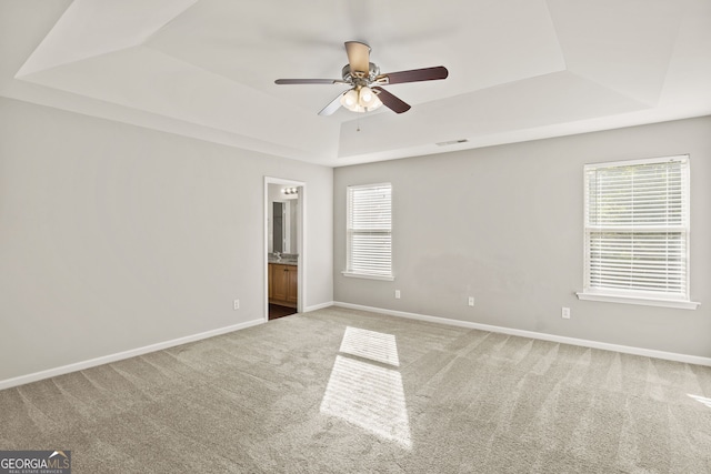 23 Brookview Dr, Newnan, GA 30265 - unfurnished room featuring plenty of natural light, carpet flooring, ceiling fan, and a tray ceiling