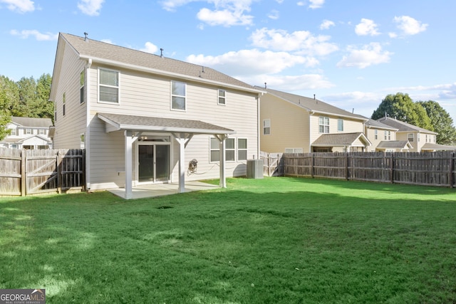 rear view of house featuring a patio and a yard