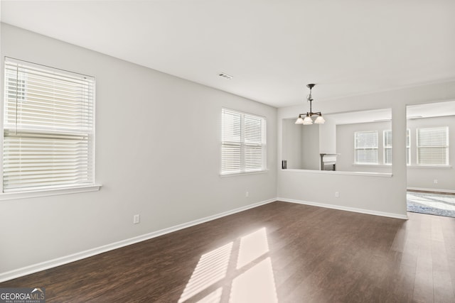 23 Brookview Dr, Newnan, GA 30265 - unfurnished dining area featuring baseboards, a notable chandelier, dark wood-style floors, and visible vents