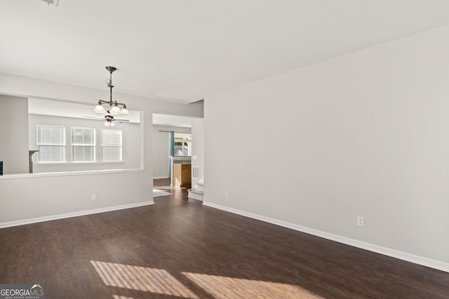 spare room with ceiling fan and dark wood-type flooring