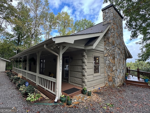 view of side of property featuring covered porch