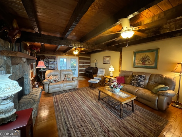 living room with wood ceiling, beam ceiling, a fireplace, hardwood / wood-style floors, and ceiling fan